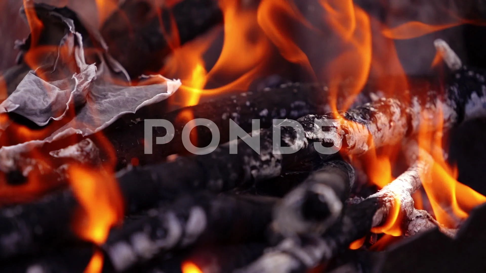 Burning fire over the smouldering logs. ... | Stock Video | Pond5