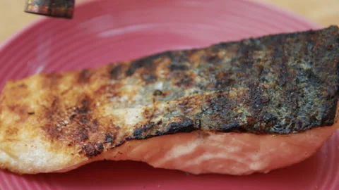 Burning fire pieces of fish lying on a plate Stock Footage 154924058