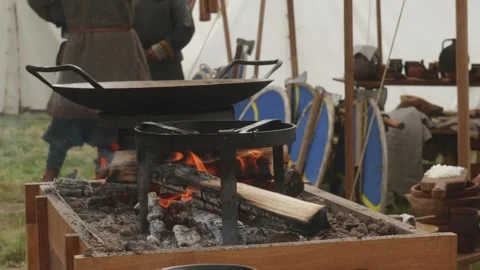 Burning Fire Under Baking Pan and Cooking Pot Stand Side View Stock Footage 319948132