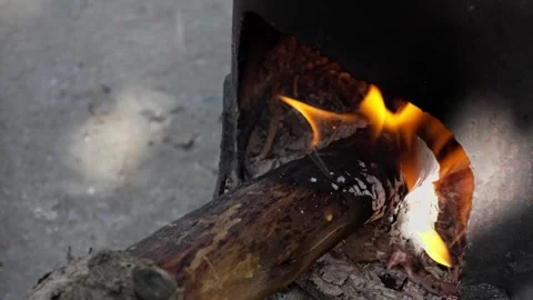 Burning fire under a cauldron outdoors Stock Footage 318079557