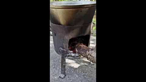 Burning fire under a cauldron outdoors Stock Footage 318079568