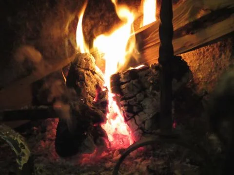 Burning fireplace with fire flames on black background Stock Photos
