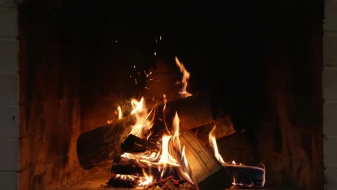 Burning Fireplace Providing Warmth and Comfort in Winter. Warm Flames Dance on Stock Footage 321116792