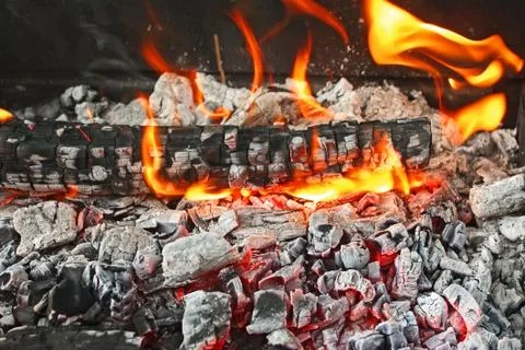 Burning firewood with ashes Stock Photos
