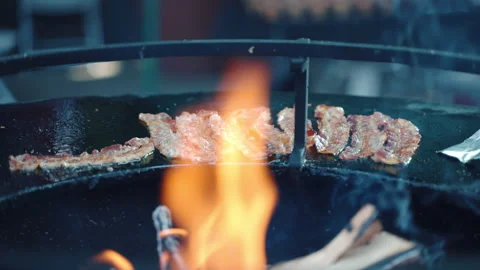 Burning firewood inside the black round barbecue smoker, process of barbeque Stock Footage 223342501