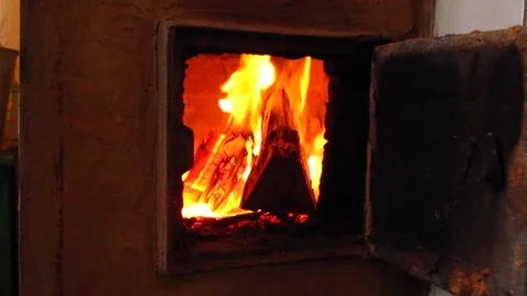 Burning firewood in old rustic brick stove with open door. Stock Footage 83035281