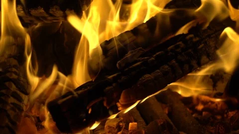 Burning firewoods with orange flame in slow motion, closeup view. Video stock 121343485