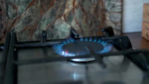 The Burning Flame Of A Modern Kitchen Gas Burner. Turning off the Gas on the Sto Stock Footage 154351983