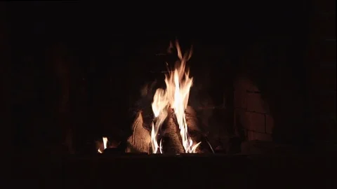 Burning flame in a red brick fireplace in a country house in the evening Stock Footage 123705045