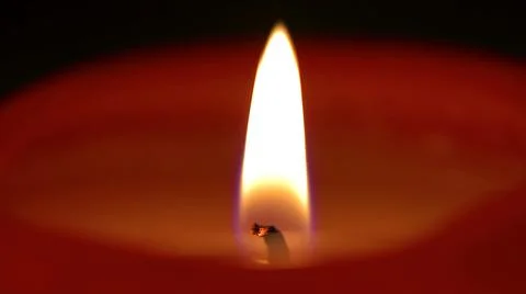 Burning flame of a red candle macro shooting Stock Photos