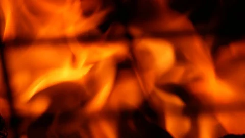 Burning flames. Macro through the metal grill. Stock Footage 107735023