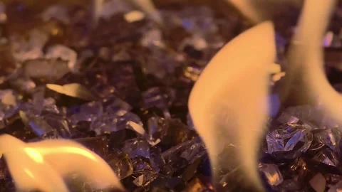 Burning Flames Over Decorative Fire Glass in Modern Gas Fire Pit Close Up Stock Footage 338366525