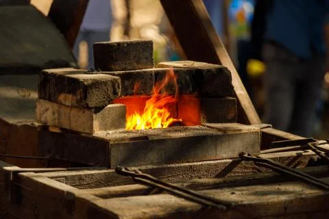 A burning forge made of bricks in nature Stock Photos