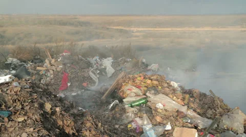 Burning garbage dump, ecological pollution. spontaneous garbage dump. Stock Footage 33037535