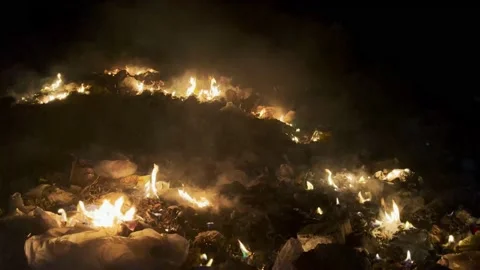 Burning garbage dump full of plastic causing toxic smoke causing the air poll Stock Footage 209156617