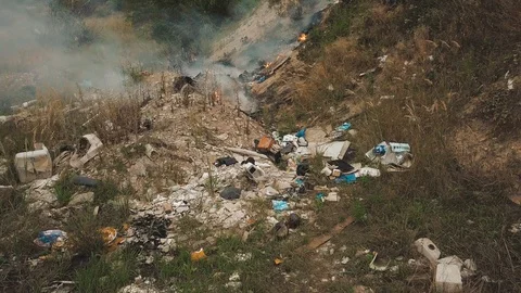 Burning garbage in an illegal dump. Aerial view Stock Footage 113469559