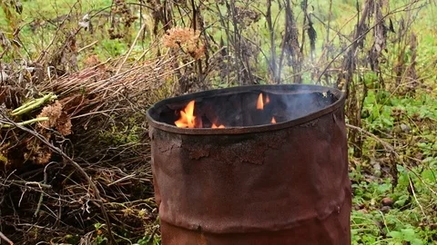 Burning garbage in an iron barrel, close-up Stock Footage 119175286