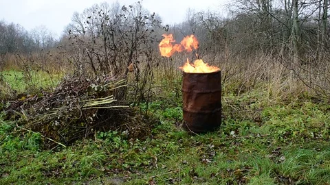 Burning garbage in an iron barrel Stock Footage 119175291