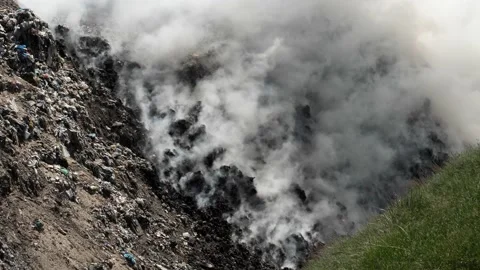 Burning garbage in a landfill. Thick smoke, air and air pollution. Stock Footage 154339689