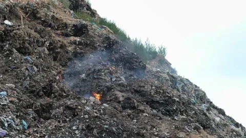 Burning garbage in a large landfill, garbage dump Stock Footage 203889951