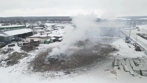 Burning garbage in the winter on the street. 4k drone footage Stock Footage 172011445