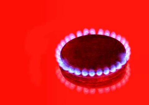 Burning gas ring on red background. Stock Photos