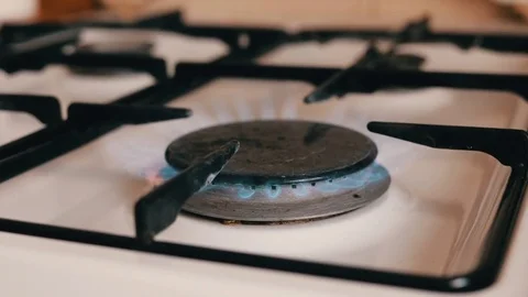 Burning gas stove in the kitchen Stockbeeldmateriaal 74826284