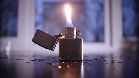 Burning gasoline lighter in the rain Stock Footage 153117087