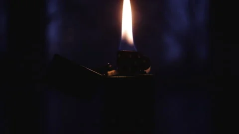 A burning gasoline lighter stands on a table not against a dark background Stock-Footage 153117030