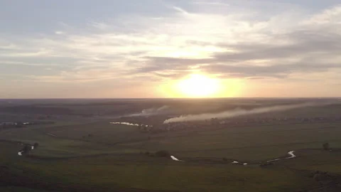 Burning grass in the field. the start of the fire. at sunset a field in smoke Stock-Footage 138364520