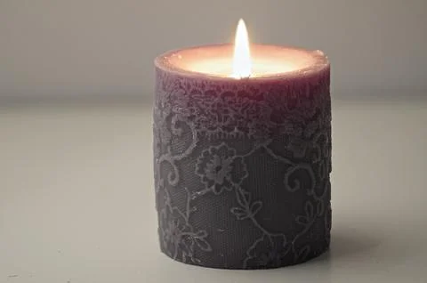 Burning grey candle Stock Photos