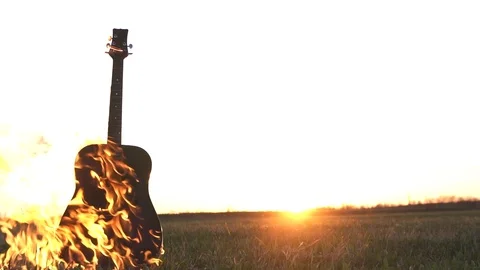 Burning guitar on fire in the field Stock Footage 89509273