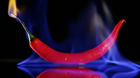 Burning hot Chilli pepper with flame on black Stock Footage
