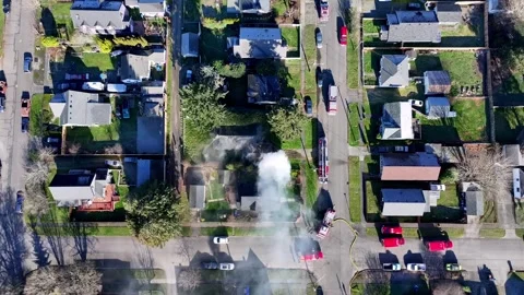 Burning House Getting Extinguished By Fire Fighters. - aerial shot Stock Footage 301893245