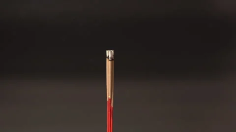 Burning incense stick with gentle aromatic smoke rising in dark background,.. Stock Footage 315513910