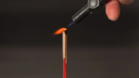 Burning incense stick with small orange flame and aromatic smoke, black bac.. Stock Footage 315513927