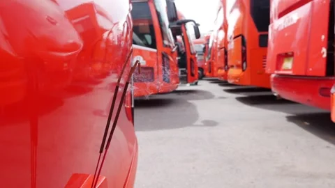 Burning incense sticks emit soft smoke from the bumper of a parked bus Stock Footage 314664983