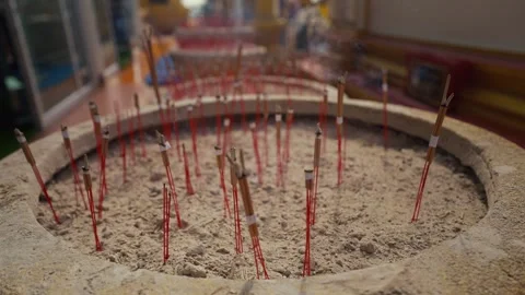 Burning incense sticks inside a large metal container. Incenses or joss burning. Stock Footage 263812147