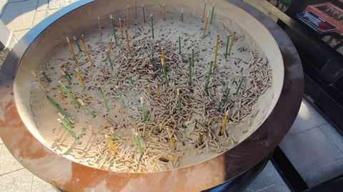 Burning incense sticks inside a large metal container in the Japanese temple. Stock Footage 269154961