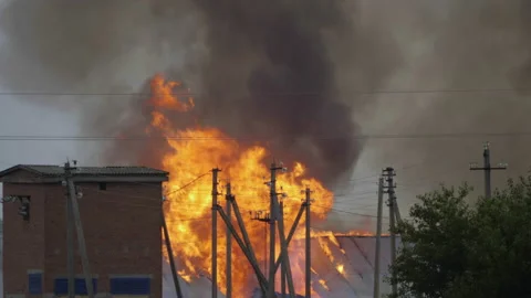 Burning industrial facility in town Stock-Footage 196339678