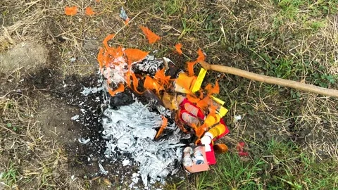 Burning Joss Papers In Front Of A Tomb, Rod Poking Joss Papers Into The Fire Stock Footage 309580206