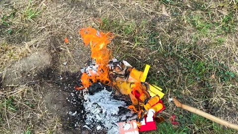 Burning Joss Papers, Hand Put Joss Paper Offering To See Off Their Ancestors Stock Footage 308807471