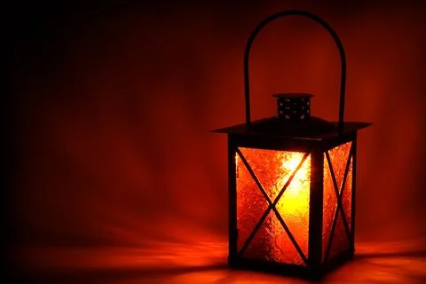 Burning lantern on dark background Stock Photos