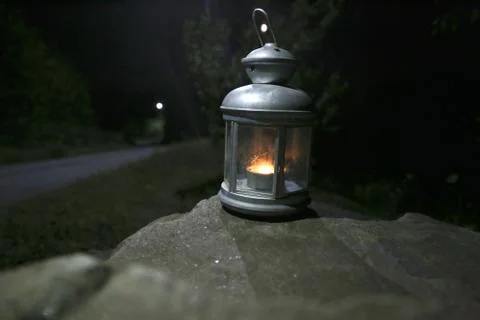 Burning lantern on a stone in the moonlight 库存照片
