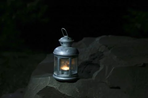 Burning lantern on a stone in the moonlight 库存照片