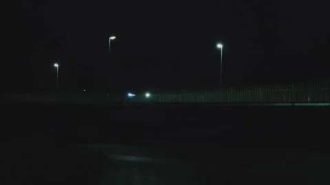 Burning lanterns in the dark, a bridge and a moving car.Detective and crime Stock Footage 296363155