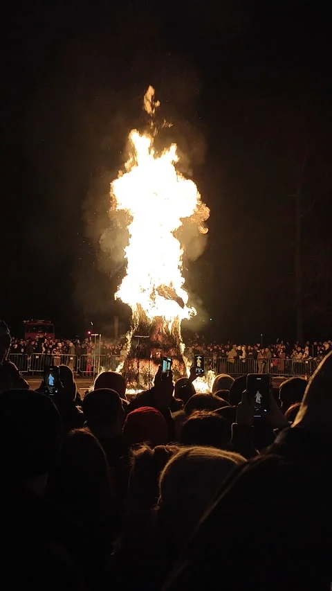 Burning large straw effigy Winter square street Maslenitsa holiday Vertical Stock Footage 305040815