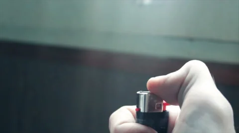 Burning lighter in the hand of a young man Video stock 68616372