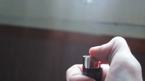 Burning lighter in the hand of a young man Stock Footage 68616394