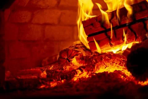 Burning log of wood in a fireplace close-up. Stock Photos